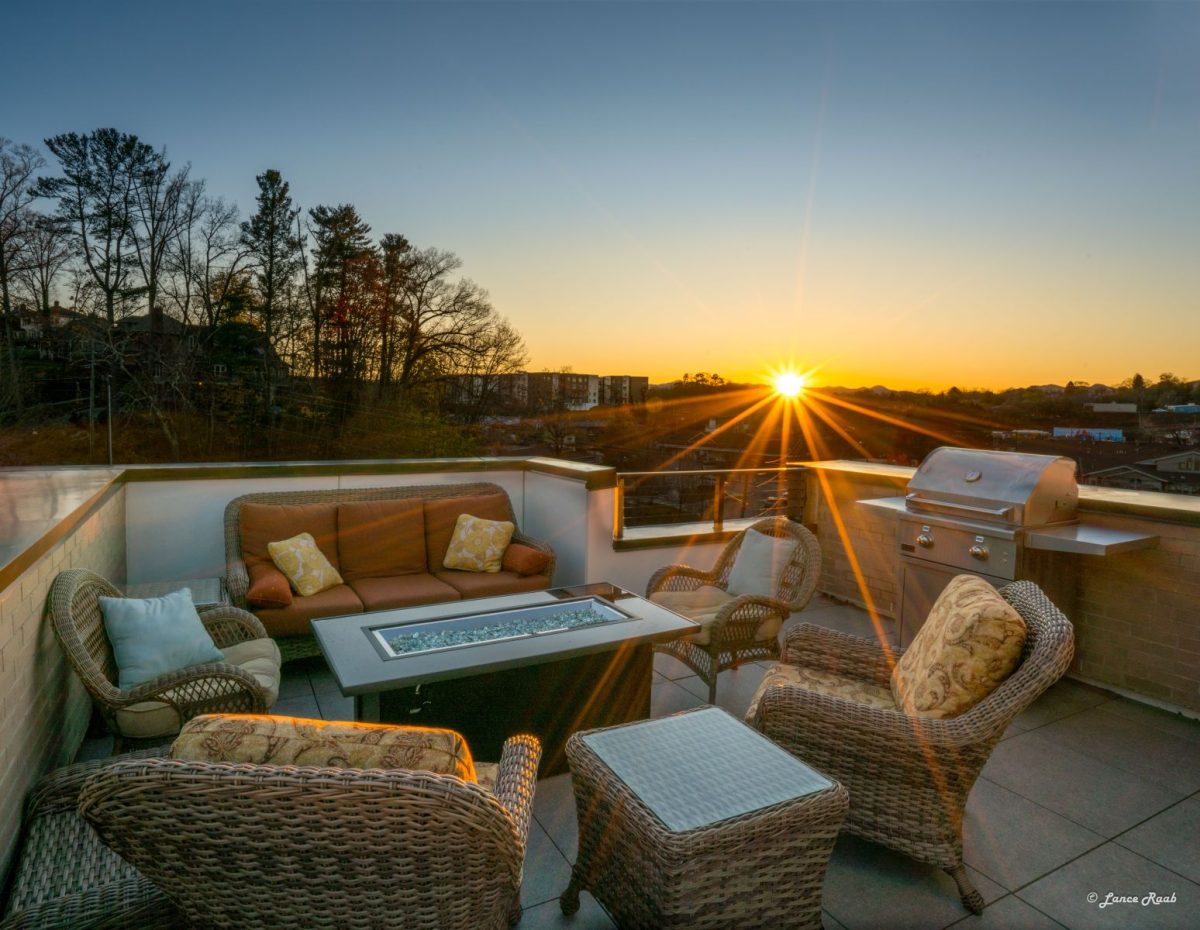 Sunset scene on a rooftop with outdoor furniture