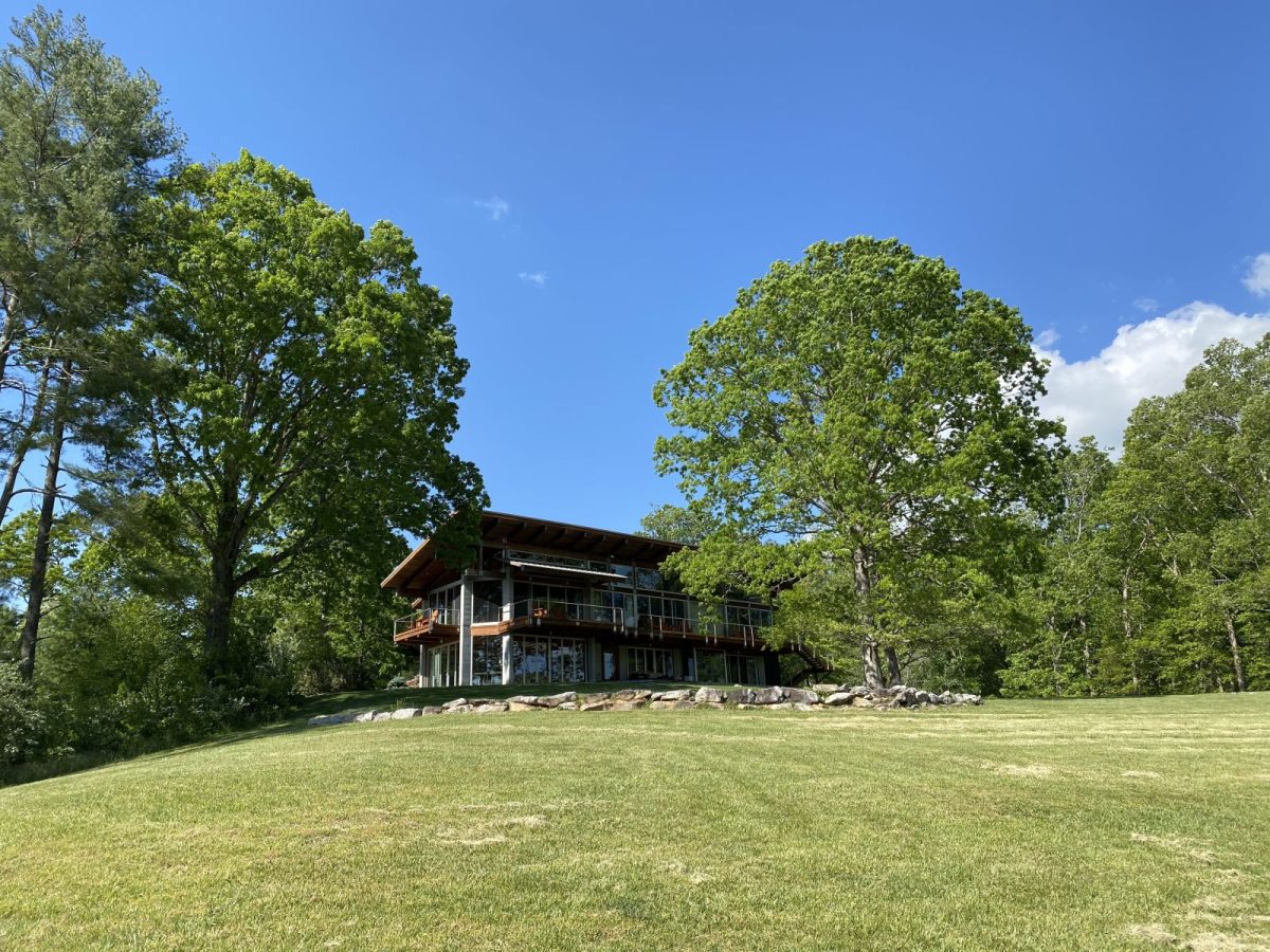 Large mountain vacation home surrounded by trees and open lawn in Western North Carolina, ideal for group getaways.
