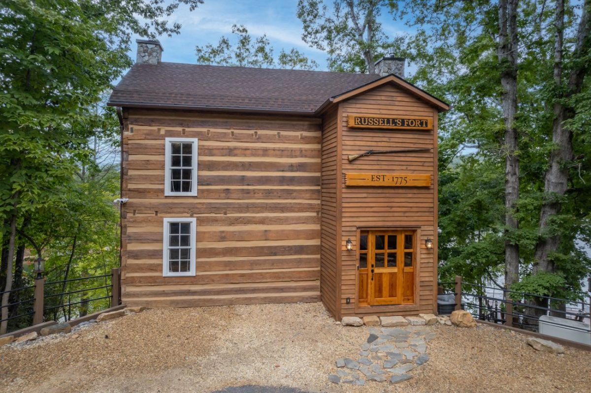 Historic Russell’s Fort log cabin vacation rental at White Oak Point near Lake Lure, North Carolina, featuring traditional Appalachian timber construction and an “Est. 1775” sign.