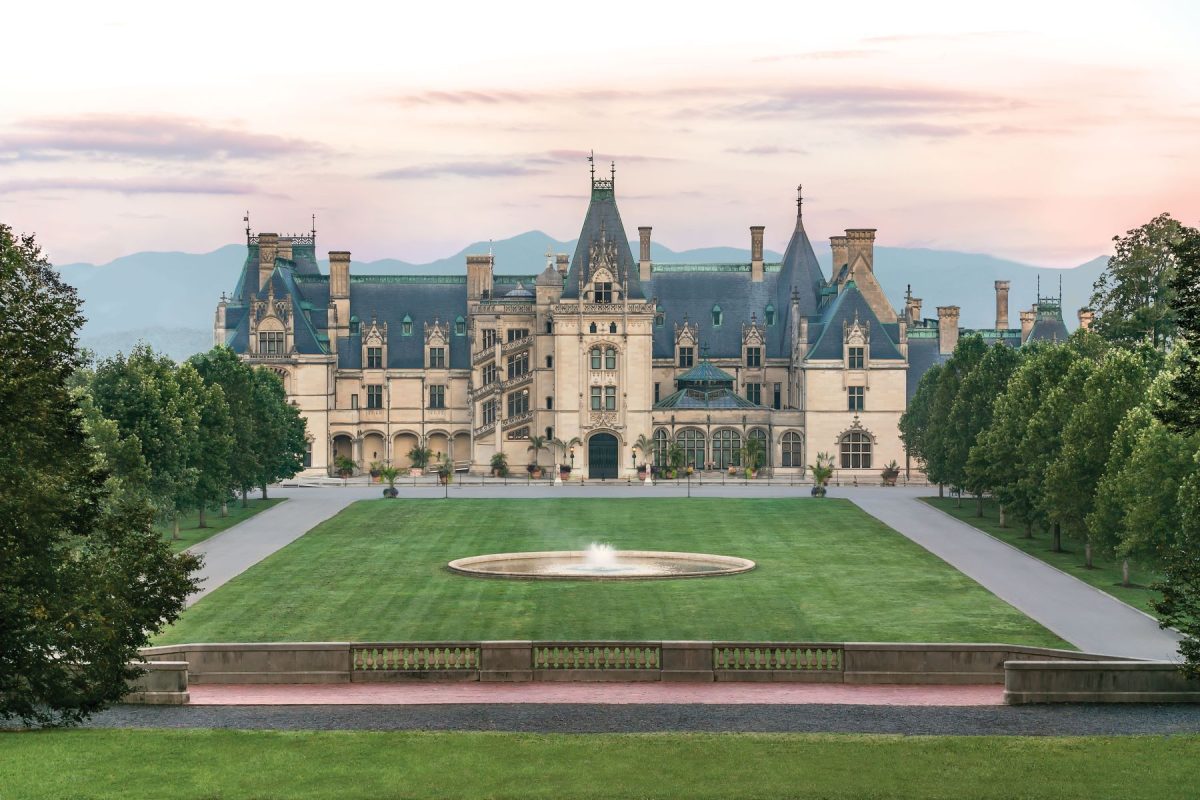 Biltmore Estate in Asheville North Carolina with its historic mansion, formal lawn, fountain, and Blue Ridge Mountains in the background