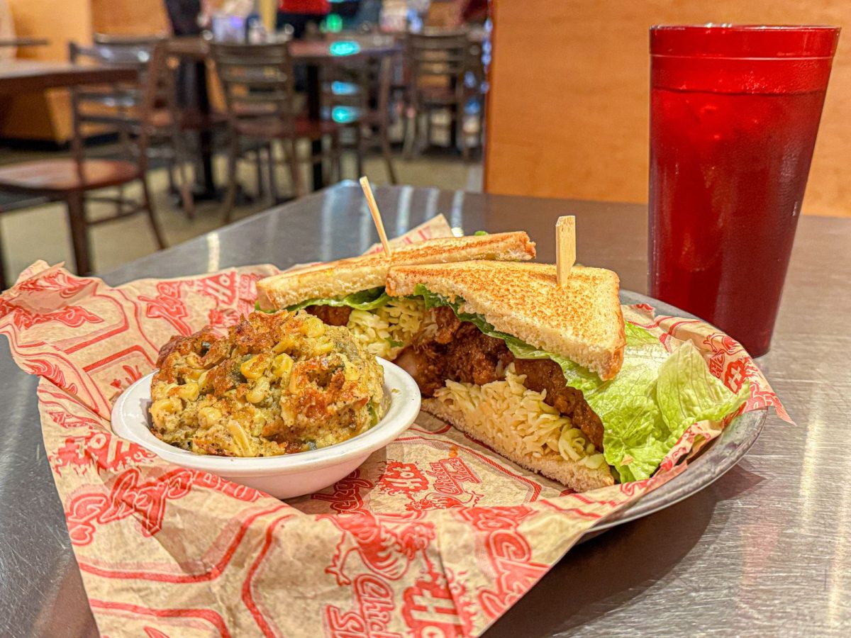 served with creamy corn pudding and a glass of iced tea.
