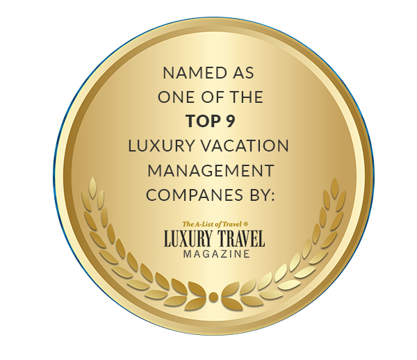 Gold medal badge announcing top 9 luxury vacation management companies by Luxury Travel Magazine, with laurel accents.
