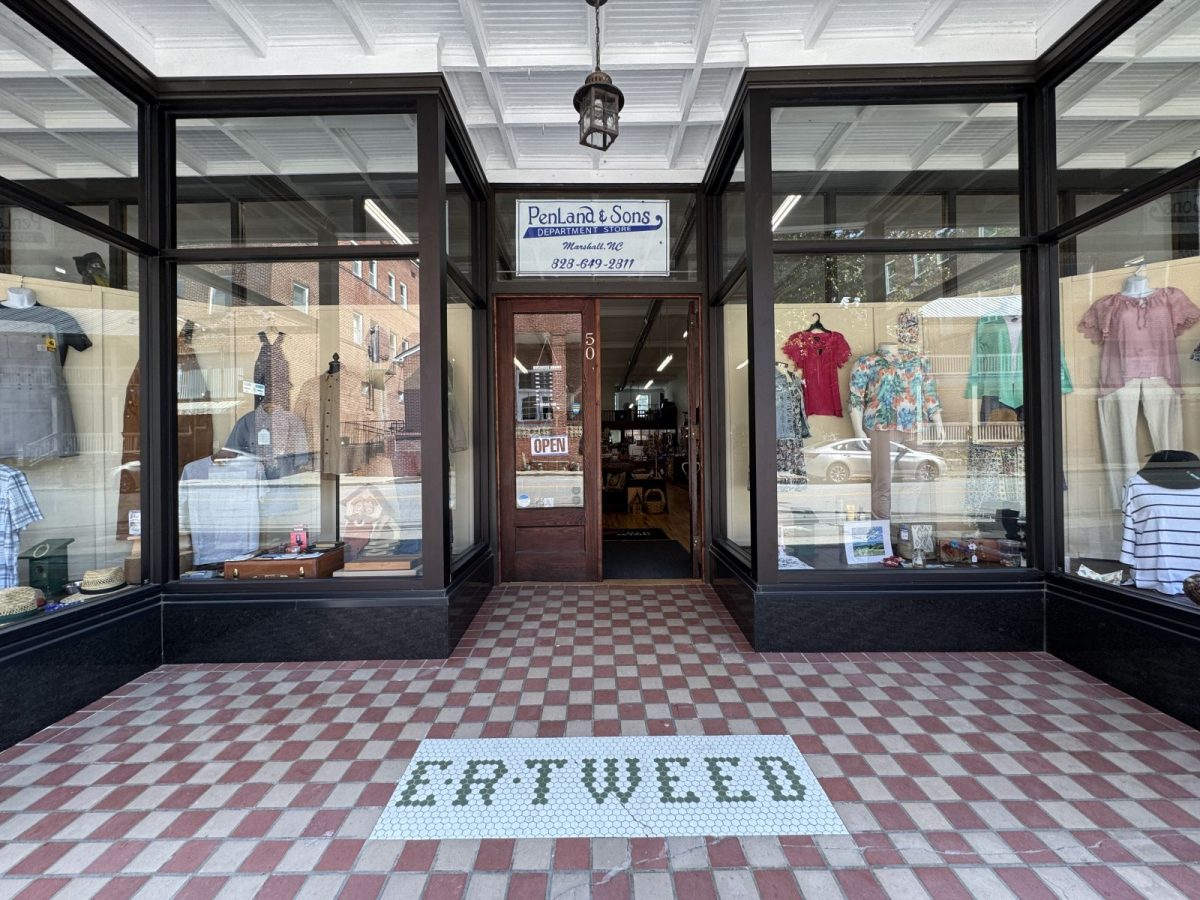 Historic storefront of Penland & Sons Department Store in downtown Marshall, North Carolina, featuring large display windows, original tiled entryway, and classic architecture.