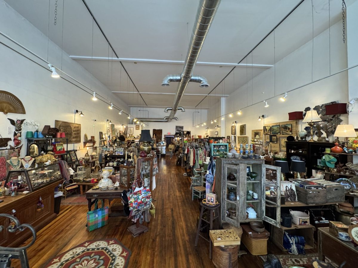 Interior of The Honey Hole in downtown Marshall, North Carolina, featuring rows of antiques, vintage furniture, collectibles, artwork, jewelry, home décor, and unique treasures displayed throughout the spacious shop.