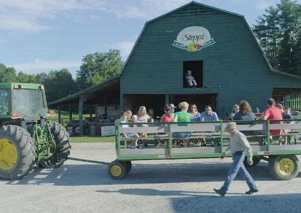 Families ride in a tractor-pulled wagon outside Stepp’s Hillcrest Orchard barn in Hendersonville, North Carolina.