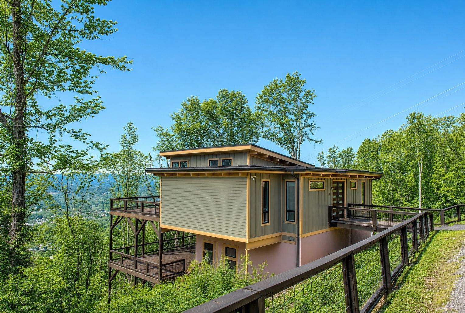 Skyline Ridge, a modern mountainside vacation home near Asheville, North Carolina, featuring expansive wraparound decks, contemporary architecture, and sweeping Blue Ridge Mountain views.