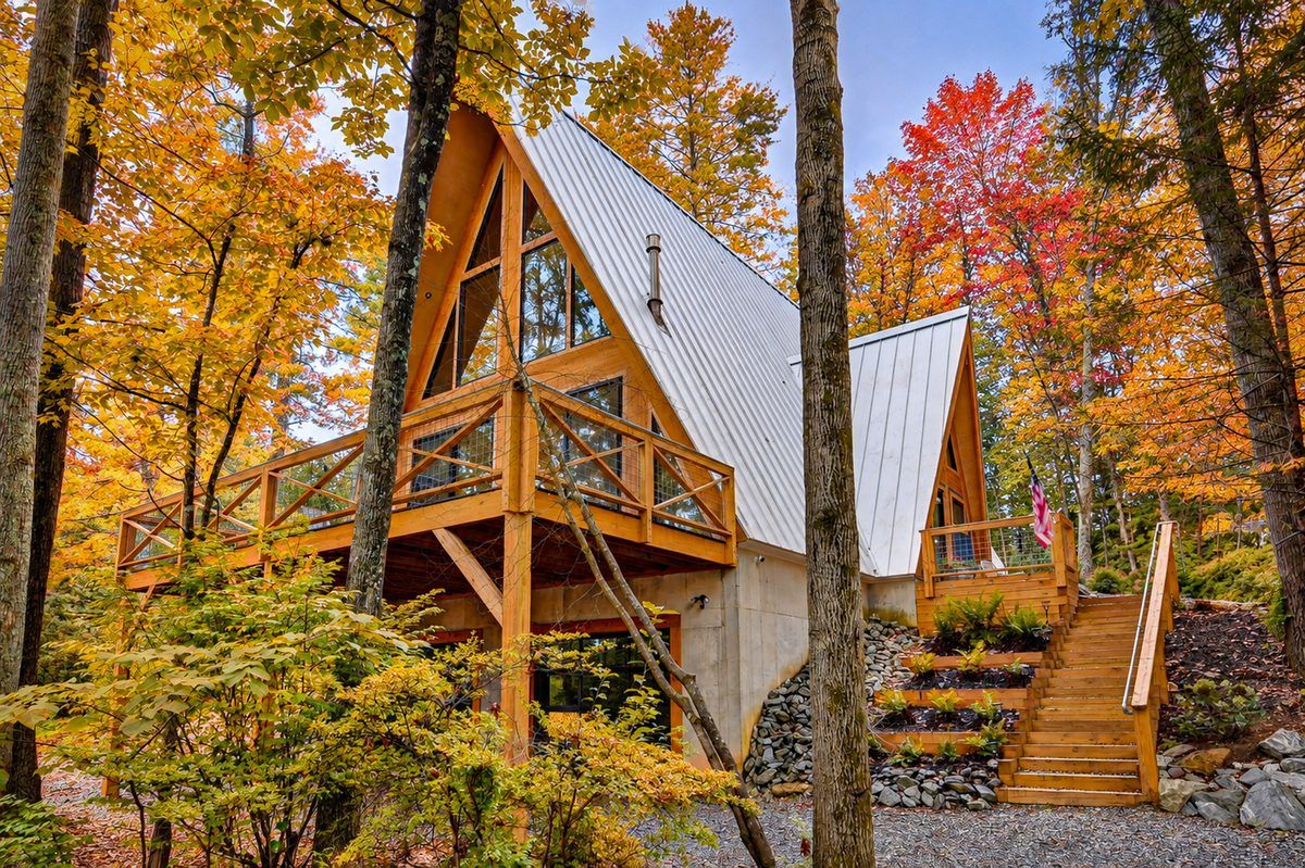 A-Frame Nest vacation home surrounded by brilliant red, orange and golden fall foliage in the mountains of Western North Carolina.