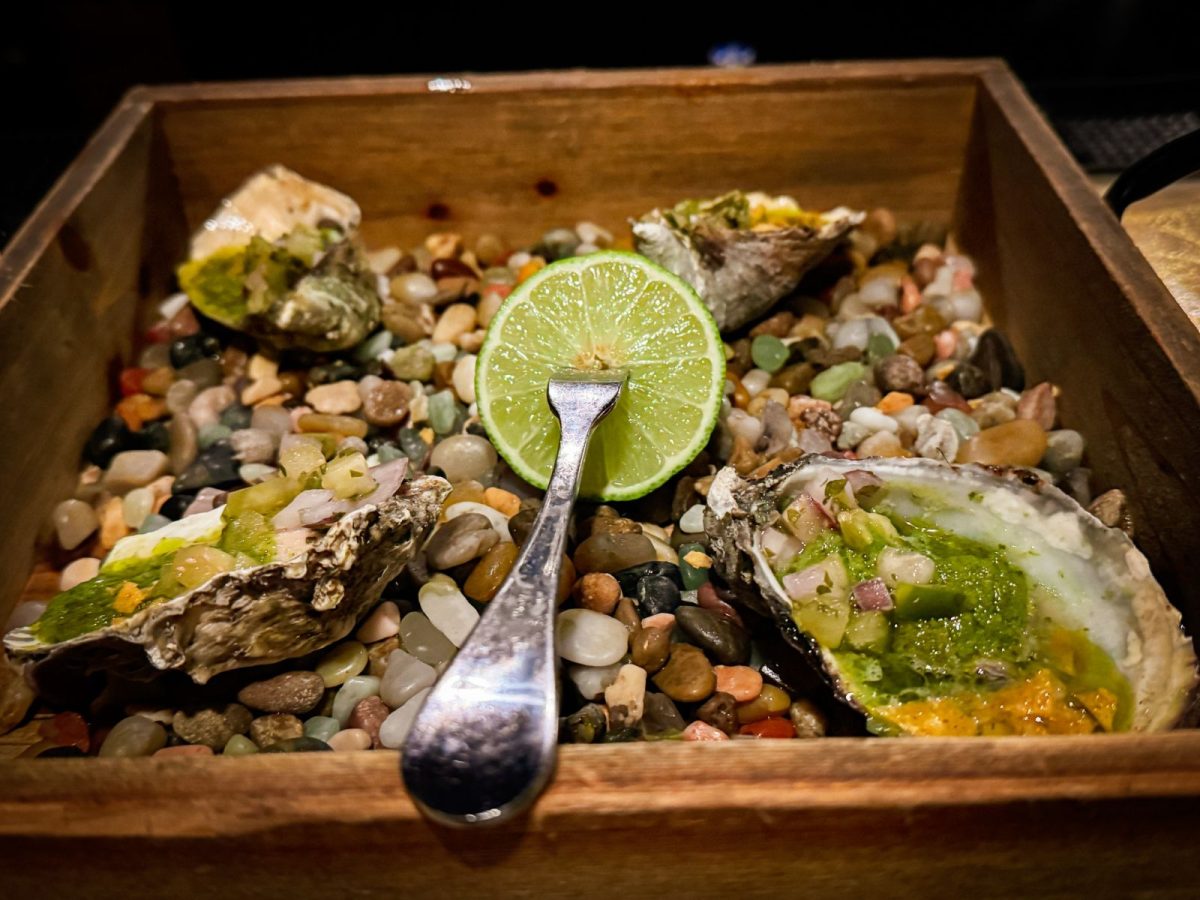 Roasted oysters with lime, peppers and herbs served at Xico Cocina de Fuego in Asheville.